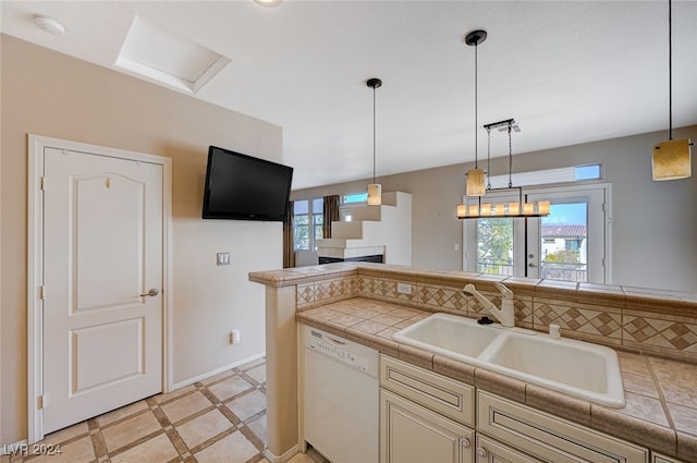 kitchen featuring a wealth of natural light, dishwasher, and pendant lighting