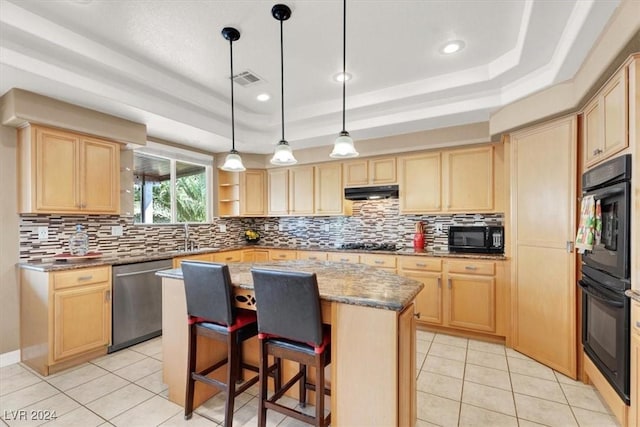 kitchen featuring a kitchen island, a tray ceiling, black appliances, light brown cabinets, and light tile patterned flooring