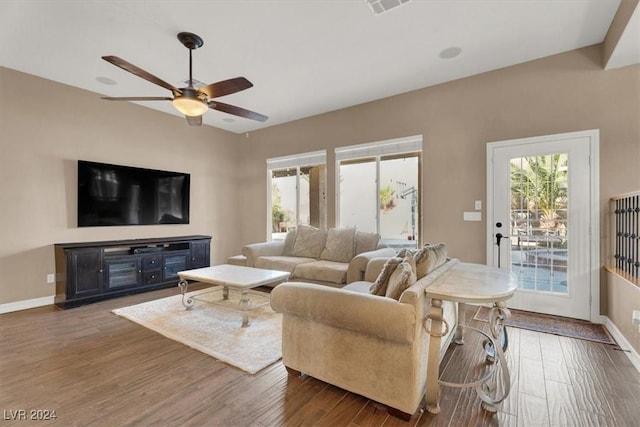 living room with ceiling fan, wood finished floors, and baseboards