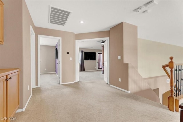 hall with recessed lighting, light colored carpet, an upstairs landing, baseboards, and visible vents