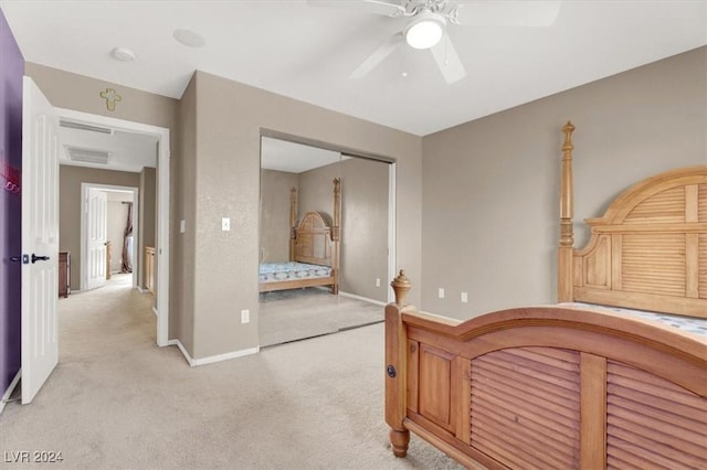 bedroom with visible vents, baseboards, a closet, and light colored carpet