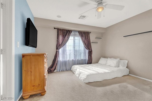 carpeted bedroom with baseboards, visible vents, and ceiling fan