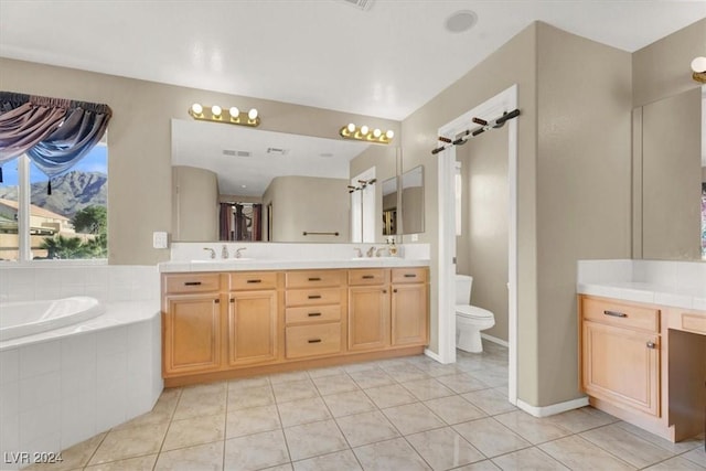 full bathroom with double vanity, a garden tub, and a sink