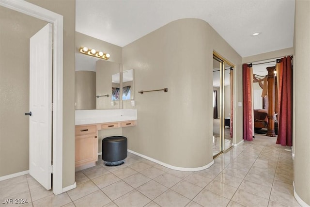 bathroom featuring baseboards, vanity, and tile patterned floors