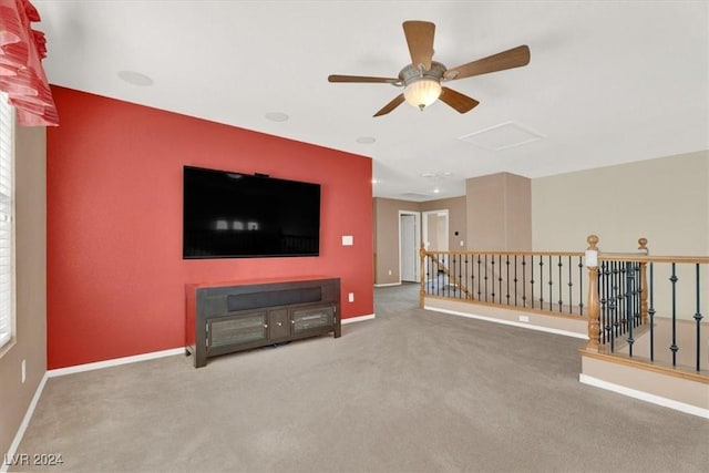 living room featuring carpet, attic access, and baseboards