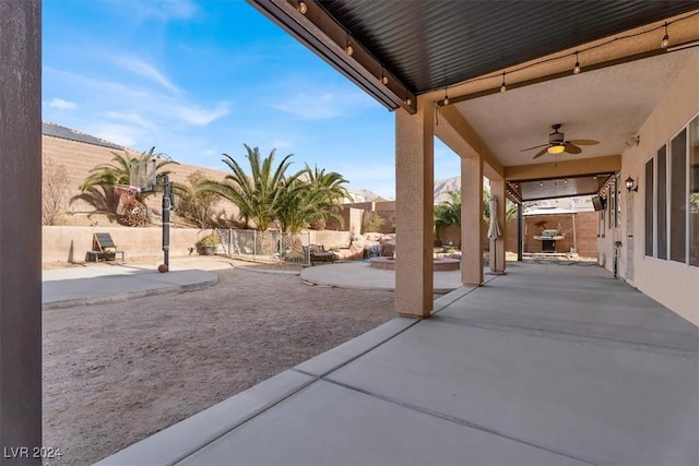 view of patio / terrace featuring ceiling fan and fence