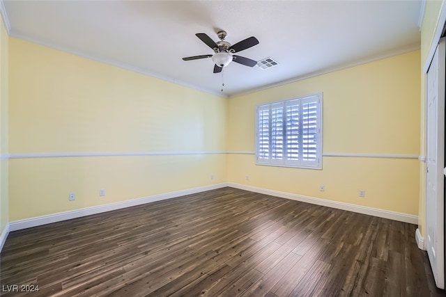 spare room featuring crown molding, ceiling fan, and dark wood-type flooring