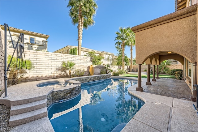 view of swimming pool featuring a patio area and an in ground hot tub