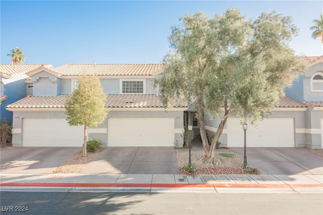 mediterranean / spanish home with a garage