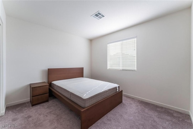 bedroom with light colored carpet