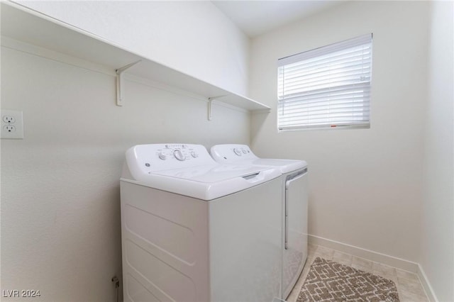 washroom featuring light tile patterned floors and washer and dryer