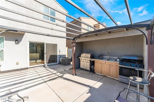 view of patio with exterior kitchen, a pergola, sink, and central AC