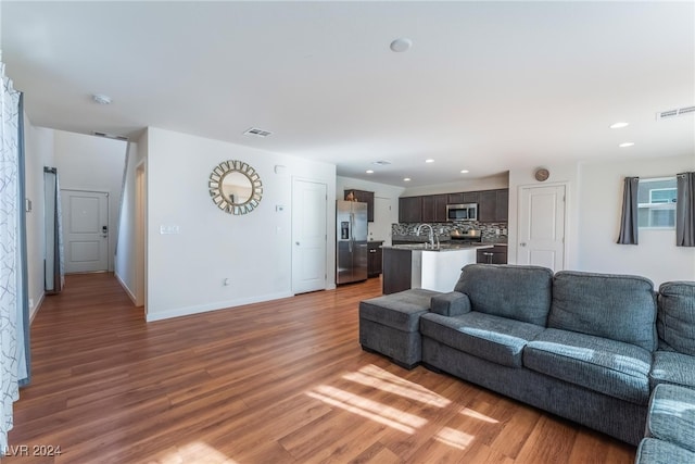 living room with sink and wood-type flooring