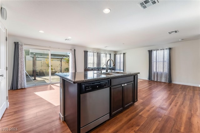 kitchen with dishwasher, wood-type flooring, an island with sink, and sink