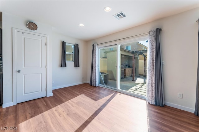 empty room with hardwood / wood-style flooring