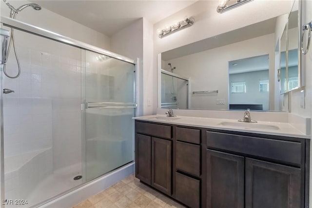 bathroom with vanity and a shower with door