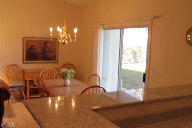 tiled dining room with a notable chandelier