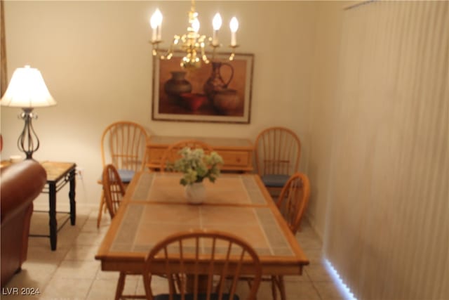 dining space with an inviting chandelier and light tile patterned flooring