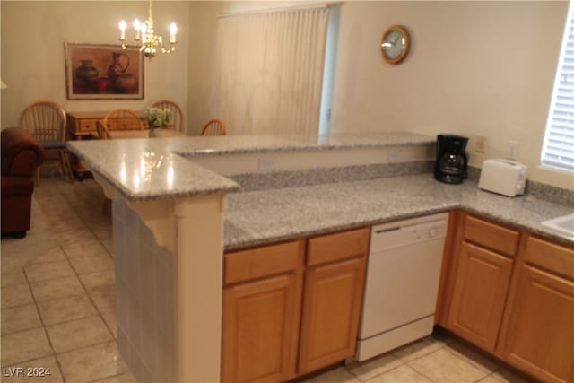 kitchen with kitchen peninsula, white dishwasher, light tile patterned floors, and a notable chandelier