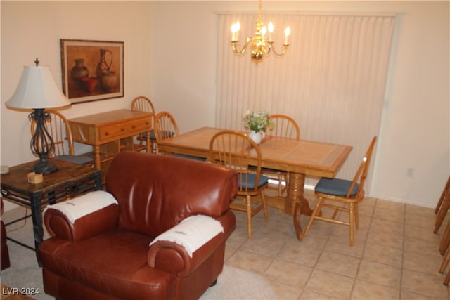 tiled dining area featuring a notable chandelier