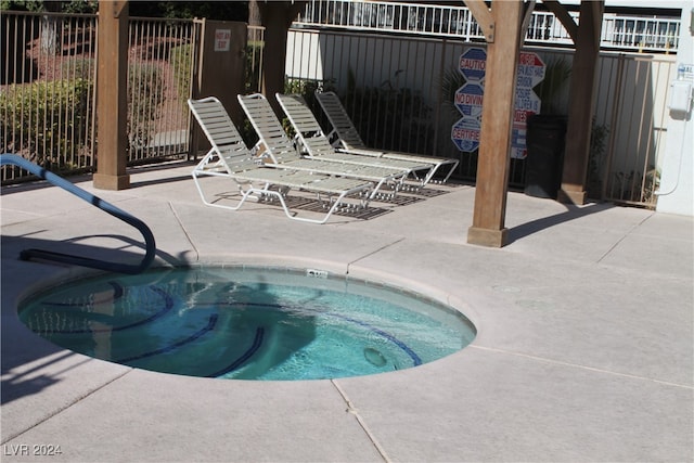 view of pool with a community hot tub and a patio