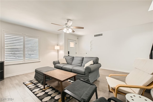 living room featuring ceiling fan and light hardwood / wood-style flooring