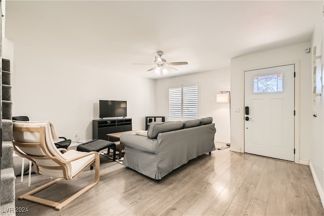 living room featuring ceiling fan and light hardwood / wood-style flooring