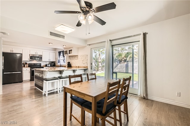 dining space featuring light hardwood / wood-style floors and ceiling fan