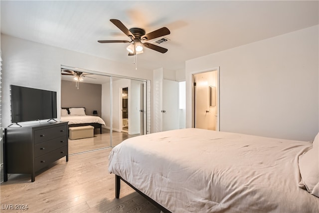 bedroom featuring ceiling fan, light hardwood / wood-style floors, and a closet