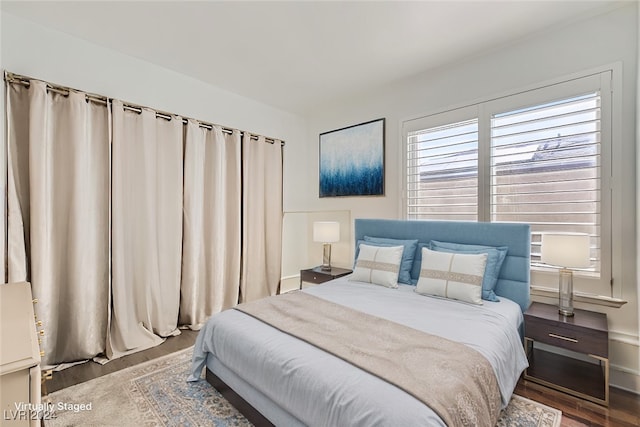 bedroom with dark hardwood / wood-style flooring