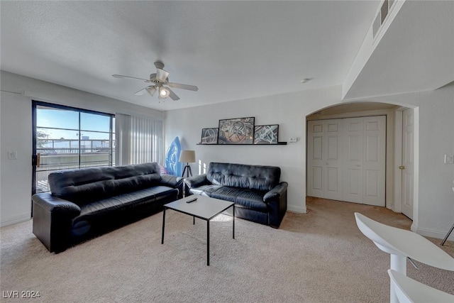 living room featuring ceiling fan and light colored carpet