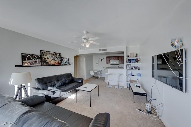 living room featuring light colored carpet and ceiling fan