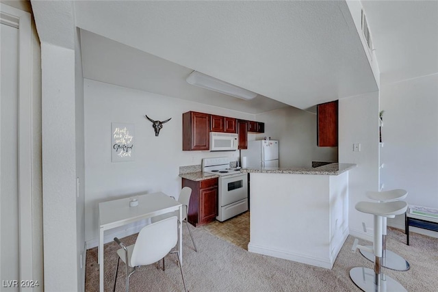 kitchen featuring kitchen peninsula, white appliances, light colored carpet, and light stone countertops