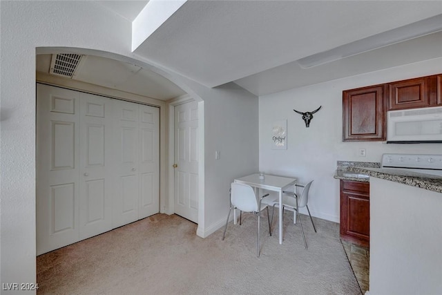 dining area with light colored carpet