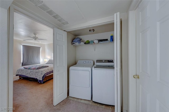 laundry area featuring light carpet, washer and clothes dryer, and ceiling fan