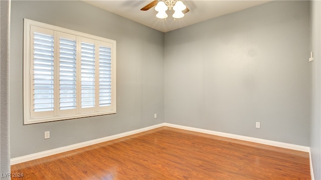 spare room with ceiling fan and wood-type flooring