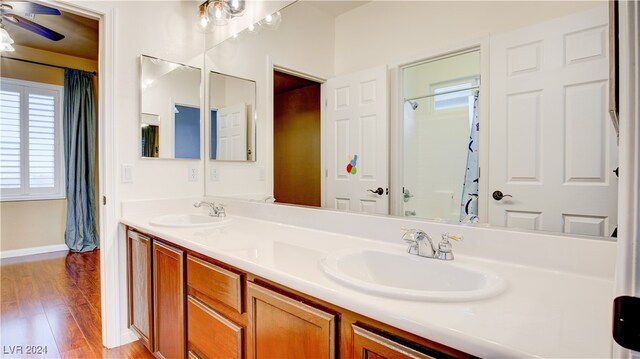 bathroom with ceiling fan, vanity, and wood-type flooring