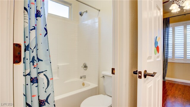 bathroom featuring hardwood / wood-style floors, toilet, and shower / bath combo