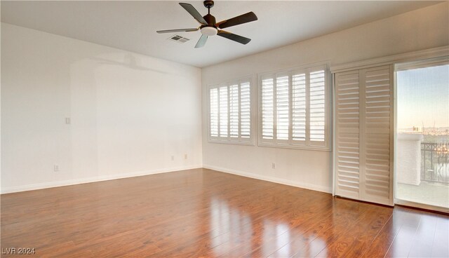 spare room featuring dark hardwood / wood-style floors and ceiling fan