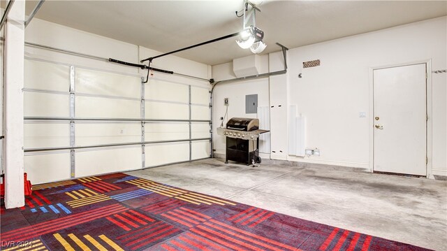 garage with electric panel and a garage door opener