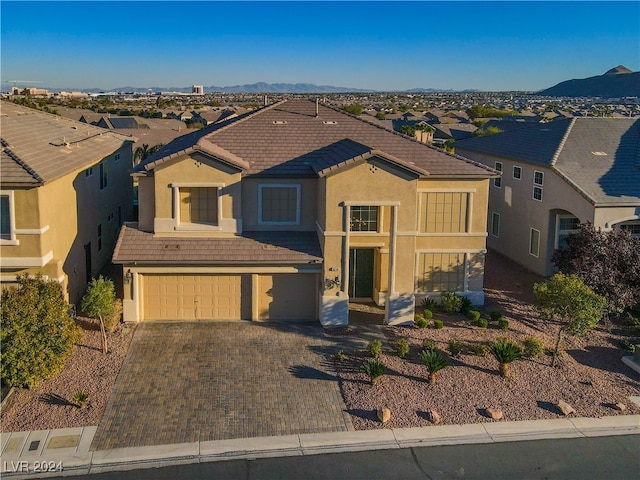 view of front of property with a mountain view and a garage