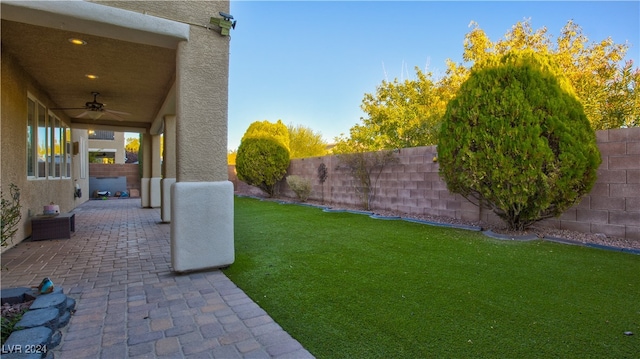 view of yard with a patio and ceiling fan