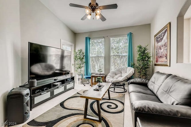 living room featuring ceiling fan and lofted ceiling