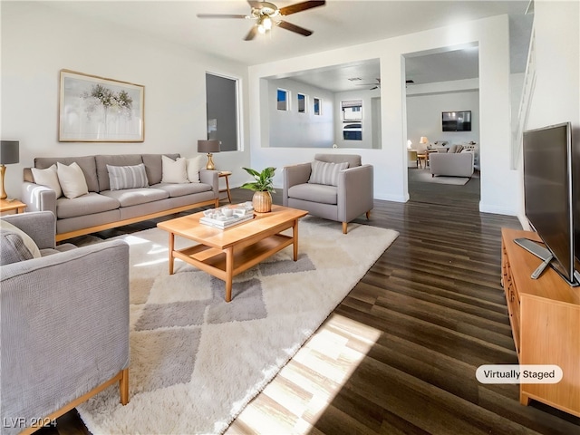 living room featuring dark hardwood / wood-style floors and ceiling fan