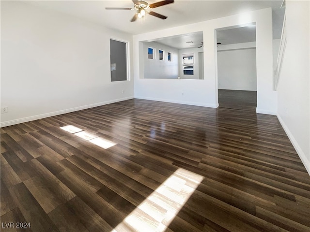 unfurnished living room featuring ceiling fan and dark hardwood / wood-style floors