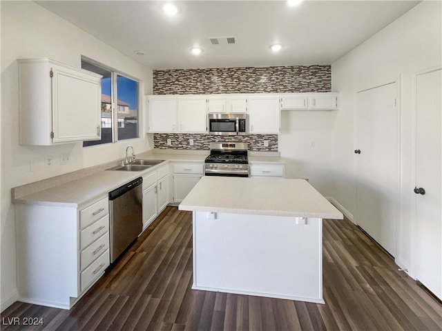 kitchen with white cabinets, a center island, dark hardwood / wood-style flooring, and stainless steel appliances