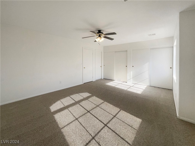 empty room featuring carpet flooring and ceiling fan