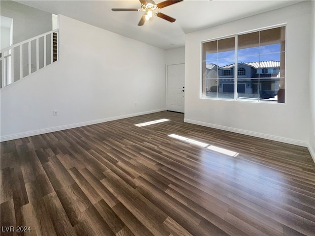 spare room with dark hardwood / wood-style floors and ceiling fan