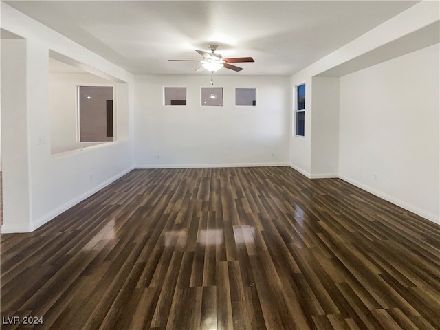 unfurnished room featuring ceiling fan and dark hardwood / wood-style flooring