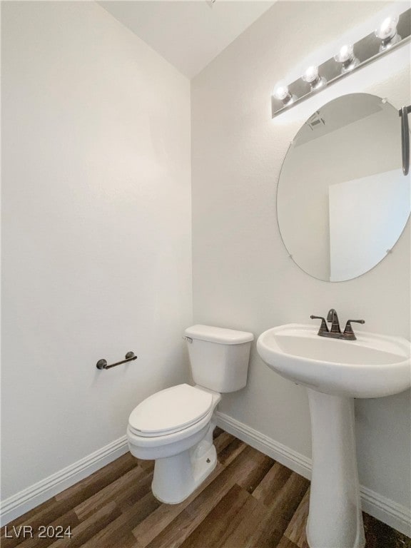 bathroom with sink, toilet, and hardwood / wood-style flooring